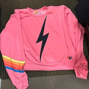Aviator Nation neon pink sweatshirt with black bolt and neon stripes
